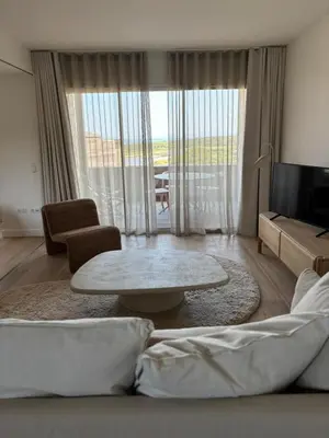 a living room with a table and a large window at T2 - sea and Corsican maquis in Bonifacio