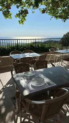 a table with chairs and a table with plates on it at Gîte U Saltu in Solaro