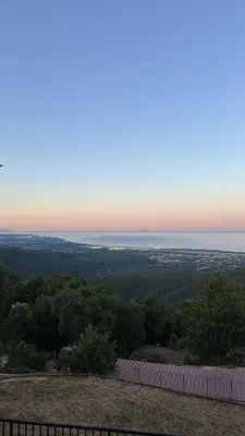 a view of the ocean from a hill with a fence at Gîte U Saltu in Solaro