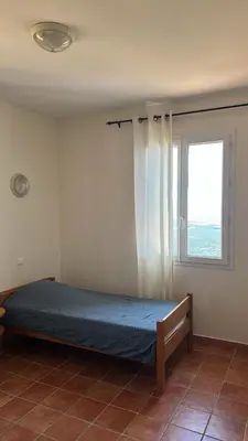 a bed in a room with a window at Gîte U Saltu in Solaro