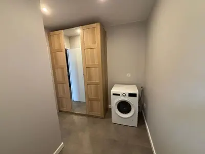 a bathroom with a washing machine in a room at 2 logements a porto vecchio in Porto-Vecchio