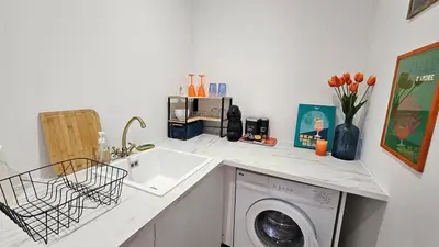 a kitchen counter with a sink and a washing machine at Casa Squarcini in Appietto