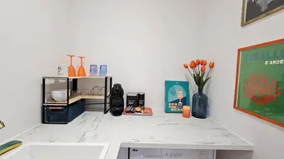 a kitchen counter with a sink and a vase of flowers at Casa Squarcini in Appietto