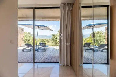 a view from the living room of a house with sliding glass doors at Villa Cala Serena in Zonza
