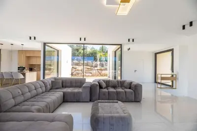 a living room with two couches and a table at Villa Cala Serena in Zonza
