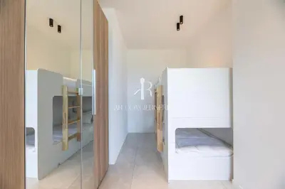 a room with two bunk beds and a mirror at Villa Cala Serena in Zonza