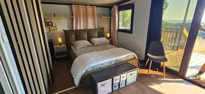 a bedroom with a large bed and a balcony at Grande Chambre tout confort 5 in Bonifacio