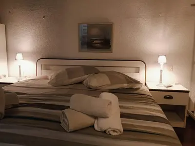 a bedroom with a bed with towels on it at Le Rêve de Mer in Ghisonaccia