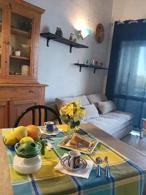 a dining room table with a yellow and green table cloth at Le Rêve de Mer in Ghisonaccia