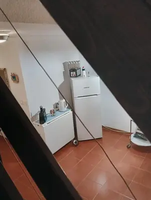 a kitchen with a white refrigerator and a counter at Le Rêve de Mer in Ghisonaccia