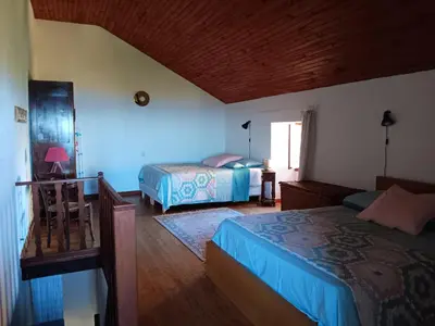a hotel room with two beds and a window at Entre mer et montagne in Valle-di-Campoloro