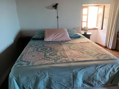 a bed with a quilt on it in a bedroom at Entre mer et montagne in Valle-di-Campoloro
