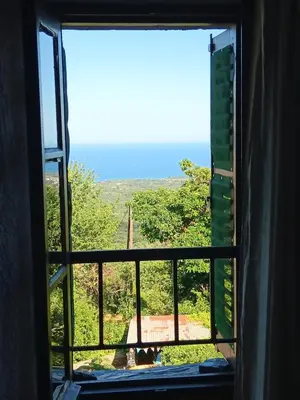 a window looking out at a view of a field at Entre mer et montagne in Valle-di-Campoloro