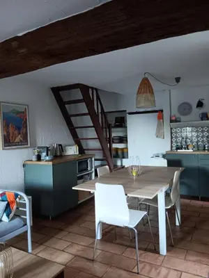 a kitchen and dining room with a table and chairs at Entre mer et montagne in Valle-di-Campoloro