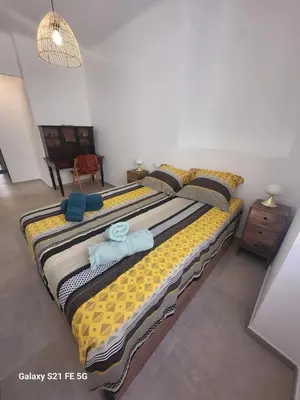 a large bed in a room with two towels on it at T2 Ajaccio centre in Ajaccio