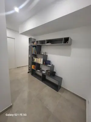 a room with a book shelf on the wall at T2 Ajaccio centre in Ajaccio