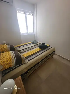 two beds sitting in a room with a window at T2 Ajaccio centre in Ajaccio