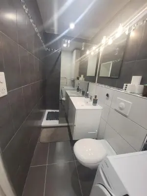 a bathroom with a white toilet and a sink at T2 Ajaccio centre in Ajaccio