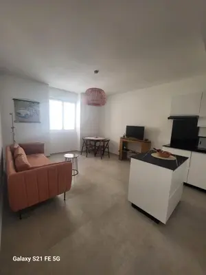 a living room with a couch and a table at T2 Ajaccio centre in Ajaccio