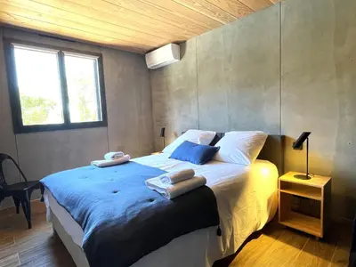 a bedroom with a large bed with towels on it at Casa Paula in Serriera