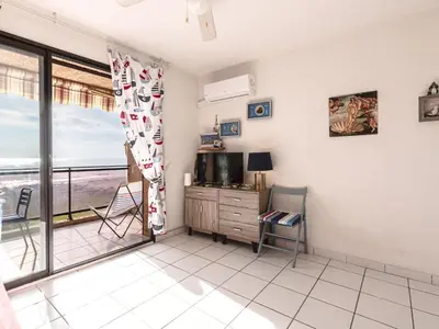a living room with a view of the ocean at Studio Marines de Moriani by Interhome in Moriani Plage