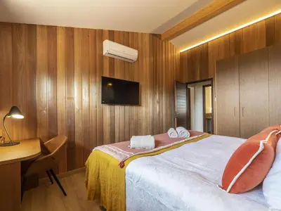 a hotel room with a bed and a desk and a television at Chalet Caseddu D'Arasu by Interhome in Sainte-Lucie de Porto-Vecchio