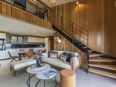 a living room with a couch and a staircase at Chalet Caseddu D'Arasu by Interhome in Sainte-Lucie de Porto-Vecchio