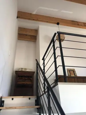a staircase in a house with wooden beams at Charming loft in Cozzano in Cozzano