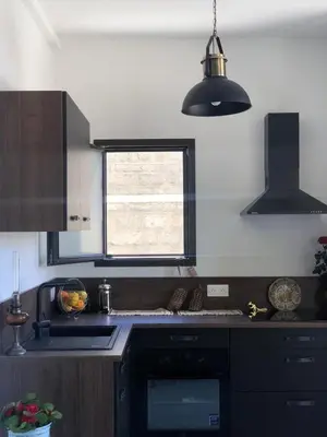 a kitchen with a stove and a sink and a window at Charming loft in Cozzano in Cozzano