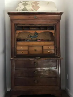 a wooden dresser with a bed on top of it at Charming loft in Cozzano in Cozzano