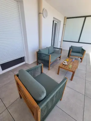 a living room with two couches and a table at Napoland Appartement T2 recent in Ajaccio