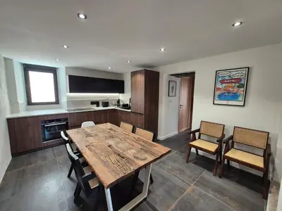 a dining room with a wooden table and chairs at Appartement de charme - Nebbiu in Vallecalle