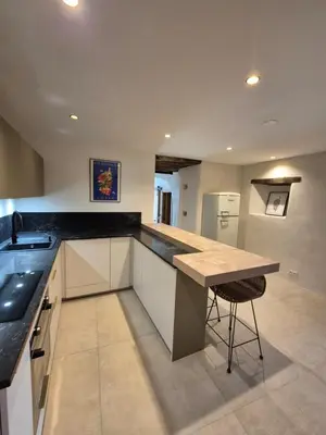 a kitchen with a counter and a island in it at Appartement de charme - Nebbiu in Vallecalle