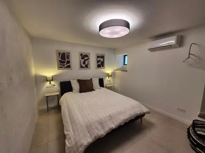 a bedroom with a bed in a room with two lamps at Appartement de charme - Nebbiu in Vallecalle