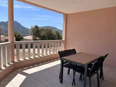 a table and chairs on a balcony with a view at Appartements neuf, rio este in Viggianello
