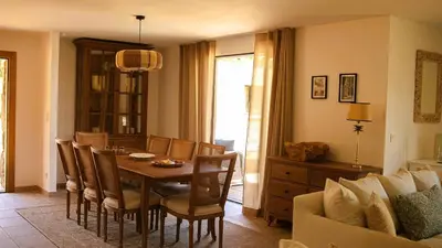a dining room with a table and chairs and a couch at Domaine de Gialla Bergerie Prugna, 6 pers, piscine chauffée, 10 mn plage in Arraggio