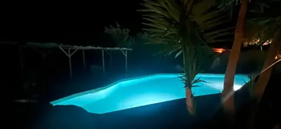 a swimming pool with chaise lounge chairs next to a resort at Villa Cala Longa - Porto Vecchio in Sotta