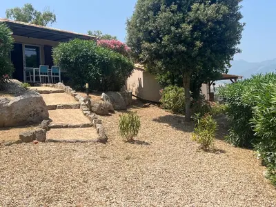 a garden with trees and a dirt road at Villa Cala Longa - Porto Vecchio in Sotta