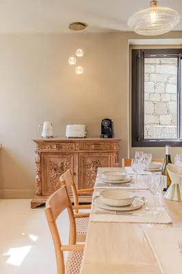 a dining room with a wooden table and chairs at Torra di l alba in Viggianello