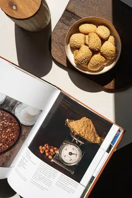 a magazine with a plate of food and a clock at Torra di l alba in Viggianello