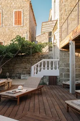 a wooden deck with a bench and a staircase at Torra di l alba in Viggianello