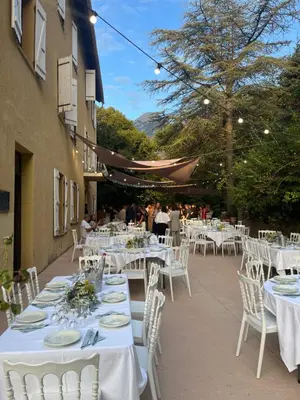 a group of tables and chairs with white table cloths at Beau Séjour in Bocognano