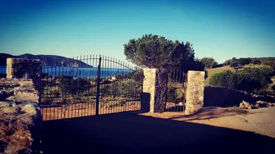 an iron gate with a view of a mountain at Les Bergeries d'Arone in Piana