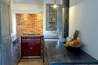 a kitchen with a stove and a bowl of fruit on the counter at Les Bergeries d'Arone in Piana