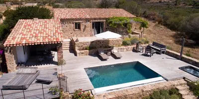 an aerial view of a house with a swimming pool at Les Bergeries d'Arone in Piana