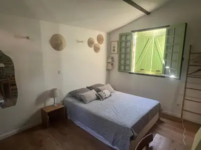 a bedroom with a bed and a window at To a Book House in Corsica - chambres d'hôtes in Oletta