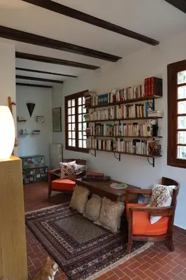 a living room with a couch and book shelves at To a Book House in Corsica - chambres d'hôtes in Oletta
