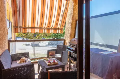 a room with chairs and a table and a window at Casa Santa Lucia - Climatisé au bord de Mer in Santa-Lucia-di-Moriani