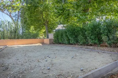 a yard with a lot of balls on the ground at Casa Santa Lucia - Climatisé au bord de Mer in Santa-Lucia-di-Moriani