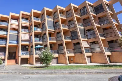 an apartment building with balconies on a street at Casa Santa Lucia - Climatisé au bord de Mer in Santa-Lucia-di-Moriani